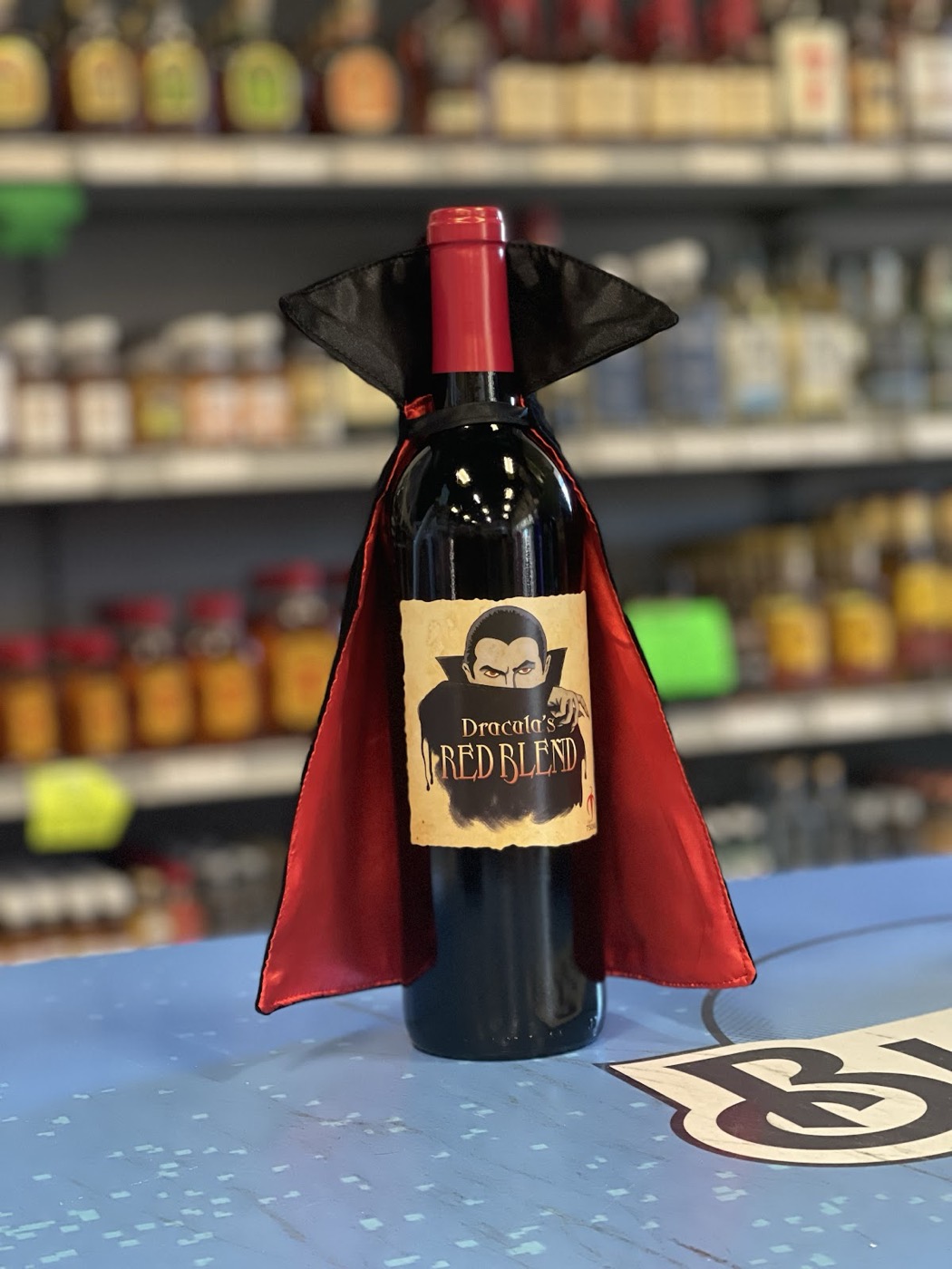 Red wine bottle dressed in a Dracula cape