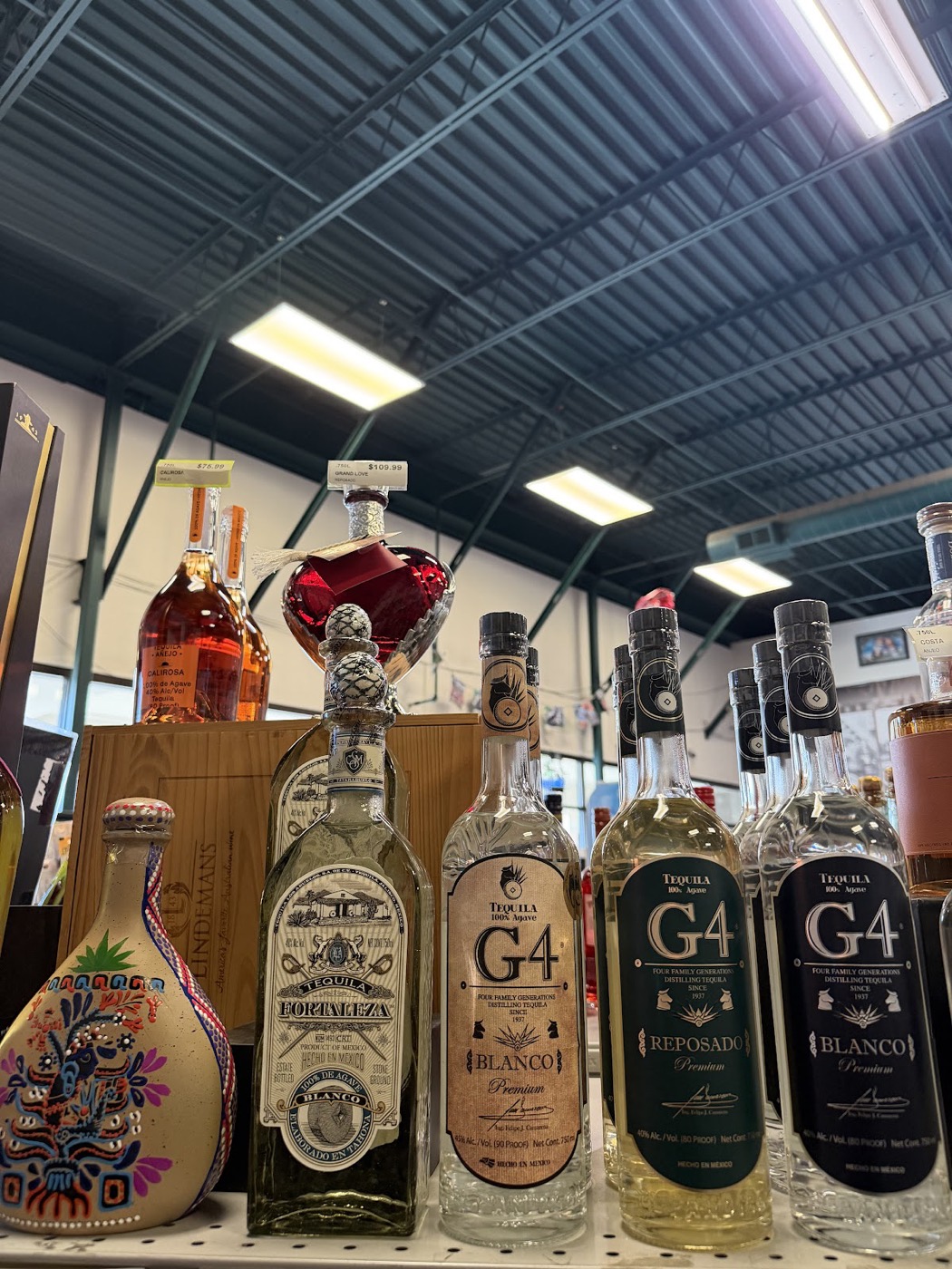 Tequila bottles lined up on the top shelf